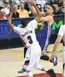  ?? STEVE DYKES/GETTY IMAGES ?? Stephen Curry, right, finished with 40 points, nine rebounds and eight assists to lead the Warriors to a 132-125 overtime victory against the Portland Trail Blazers on Monday.