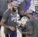  ?? AP photo ?? The Lakers’ Anthony Davis looks at their trophy for the NBA Western Conference title. The NBA Finals start Wednesday.