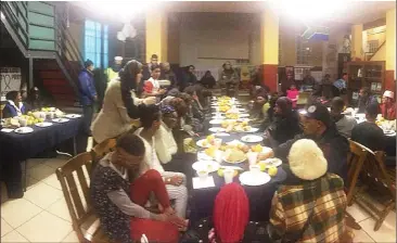  ??  ?? SHARING IS CARING: About 100 homeless people were hosted at an Iftar dinner by a number of diverse community organisati­ons working in the District Six area.