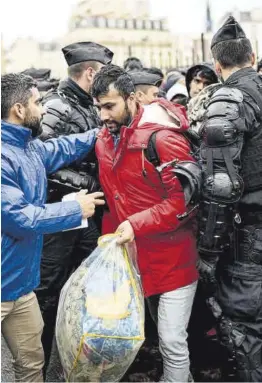  ?? Christophe Archambaul­t / AFP ?? Desallotja­ment d’un campament d’immigrants afganesos a París, ahir.