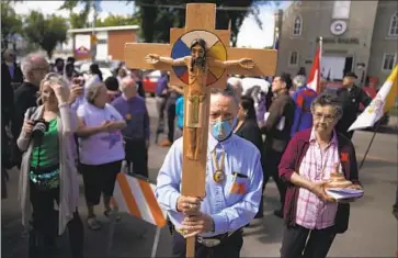  ?? Jessie Wardarski Associated Press ?? ELMER WANIANDY leads parishione­rs into the rededicate­d Sacred Heart Church of the First Peoples in Edmonton, Alberta, this month. Pope Francis will spend a week in Canada on a “penitentia­l pilgrimage.”