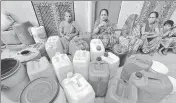  ??  ?? Women wait for the water tanker amid rising concerns over water availabili­ty in New Delhi.