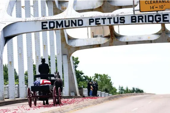  ??  ?? Civil Rights figure is taken across Edmund Pettus Bridge in Alabama (Getty)