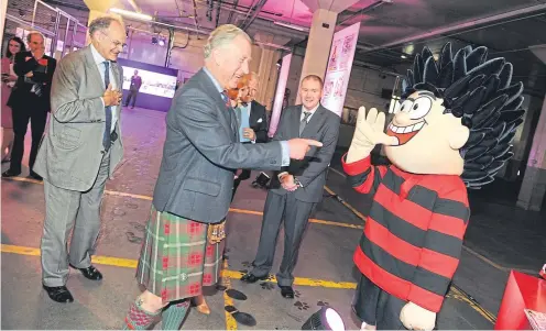  ??  ?? Dennis the Menace provided a cheeky welcome for the Duke and Duchess of Rothesay in July 2013 when they visited the Dundee premises of The Courier publisher DC Thomson &amp; Co Ltd in June. The royal couple were opening a new printing press at the firm’s Kingsway East building.