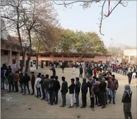  ??  ?? Voters stand in queues as they wait to cast their vote outside a polling booth during the state Assembly election, in Shaheen Bagh, New Delhi on Saturday. REUTERS