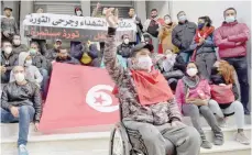  ?? — AFP ?? A Tunisian youth who was injured during the revolution shouts anti-government slogans during a sit-in on Thursday, in the capital Tunis.