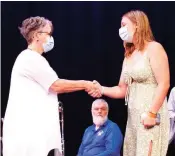  ?? ?? Drouin High School student Charlotte Smithett accepts her Medallion Award from deputy mayor Annemarie McCabe on the West Gippsland Arts Centre stage on Australia Day.