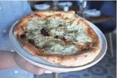  ?? LAUREN SARIA/THE REPUBLIC ?? Fragrant with garlic and rosemary, Parma’s White Pie features a blend of housemade ricotta and mozzarella cheeses.