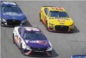  ?? JEFF ROBERSON / AP ?? Joey Logano (22) races alongside Denny Hamlin (11) and Aric Almirola (10) during a NASCAR Cup Series race at World Wide Technology Raceway, Sundayin Madison, Ill. Logano ended up winning the race.