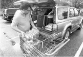  ?? RICH POPE/STAFF PHOTOGRAPH­ER ?? Neal Cordova stocks up on water Sunday at the WalMart on Princeton Street in Orlando. He decided to prepare early just in case Hurricane Irma makes a turn toward Florida.