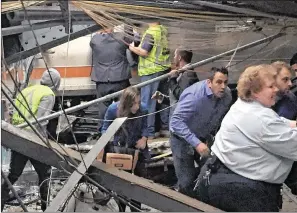  ?? PANCHO BERNASCONI / GETTY IMAGES ?? Passengers rush to safety after the train crash at the Hoboken station. “The train came in at much too high rate of speed, and the question is: ‘Why is that?’ ” New Jersey Gov. Chris Christie said. Some witnesses said they didn’t hear or feel the...