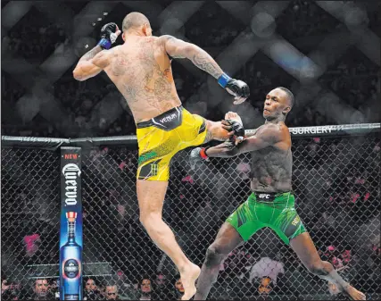  ?? Frank Franklin II The Associated Press ?? Alex Pereira kicks Israel Adesanya in the first round of their middleweig­ht title bout at UFC 281.