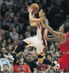  ?? Getty Images ?? The New York Knicks’ Jeremy Lin drives past the Chicago Bulls’ Derrick Rose in Monday’s game at the United Center in Chicago, Ill. The Knicks, who rode the surprising play of Linto success a month ago, have come crashing down to earth in recent weeks.