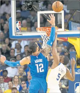  ?? RAY CHAVEZ — STAFF PHOTOGRAPH­ER ?? The Thunder’s Steven Adams and Warriors’ Kevon Looney go up for the ball Tuesday.