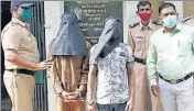  ??  ?? Bazarpeth police with the two labourers arrested for killing their colleague, in Kalyan on Friday.