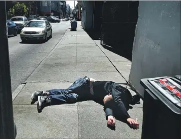  ?? Ben Margot Associated Press ?? A MAN LIES on the sidewalk beside a recyclable trash bin in San Francisco. The city that’s become a caricature of wealth inequality in the U.S. has seen a 30% increase in homeless people since the last count in 2017.