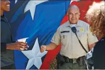  ?? Katharine Lotze/The Signal ?? School Resource Officer Javier Guzman talks with students at Hart High School on Aug. 28.