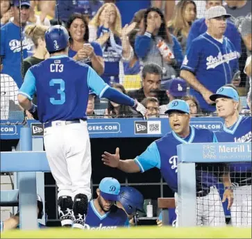  ?? Marcio Jose Sanchez Associated Press ?? CT3, also known as Chris Taylor, is greeted by manager Dave Roberts after a solo homer in the third inning.