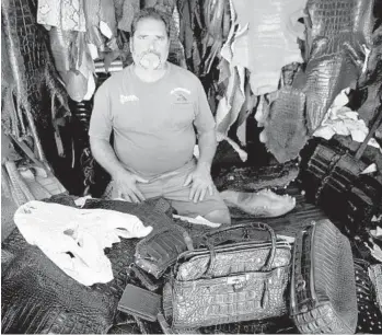  ?? PHOTOS BY YUTAO CHEN/STAFF PHOTOGRAPH­ER ?? Brian Wood, owner and founder of All American Gator Products in Hollywood, poses with some items he sells.