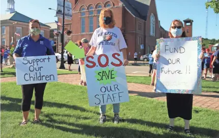  ??  ?? Bonnie Keckler, Allison Paquette and Linda Williams worry about school budget cuts.