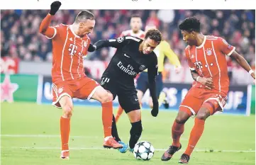  ??  ?? Paris Saint-Germain’s Brazilian forward Neymar (centre), Bayern Munich’s French midfielder Franck Ribery (left) and Bayern Munich’s Austrian defender David Alaba vie for the ball during the UEFA Champions League football match of Bayern Munich vs Paris...