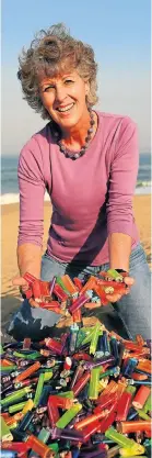  ?? Picture: Jackie Clausen ?? Kay Harrison with some of the more than 2,000 cigarette lighters she has picked up on Virginia Beach.