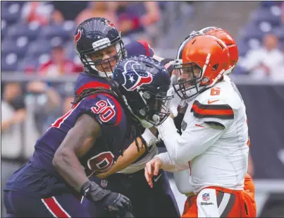  ?? The Associated Press ?? HOME-FIELD ADVANTAGE: Texans defensive end J.J. Watt, back, and defensive Jadeveon Clowney (90) pressure Cleveland quarterbac­k Baker Mayfield (6) a week ago during the second half of a 29-13 win over the Browns in Houston.