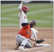  ?? (NWA Democrat-Gazette/Charlie Kaijo) ?? Arkansas catcher Casey Opitz (12) avoids the tag of Auburn’s Tyler Miller at first base during Saturday’s game.