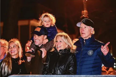  ?? MANDEL NGAN / AFP / TNS ?? President Joe Biden, with, from right, first lady Jill Biden, son Hunter Biden, grandson Beau, and daughter-in-law Melissa Cohen watch a Christmas tree lighting ceremony in Nantucket on Friday.