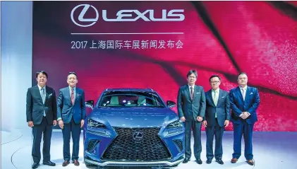  ?? PHOTOS PROVIDED TO CHINA DAILY ?? Lexus executives pose with the new Lexus NX mid-size SUV at its world premiere during the Shanghai Auto Show on April 19, 2017.