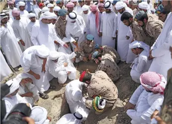  ?? Aletihad ?? Emirati air force pilot Second Lt Sultan Mohamed Ali Al Naqbi is laid to rest in Ras Al Khaimah. Left, Lt Al Naqbi