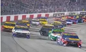  ?? AP PHOTO/STEVE HELBER ?? Joe Gibbs Racing’s Denny Hamlin, front left, and Martin Truex Jr., front right, lead the field to the start of last Saturday’s NASCAR Cup Series race in Richmond, Va. This week’s race is at Bristol Motor Speedway.