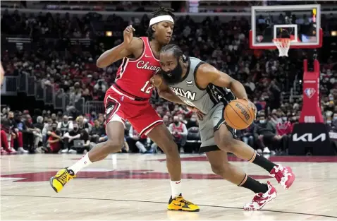  ?? (AP) ?? HARDEN ON THE MOVE. Brooklyn Nets' James Harden, right, drives on Chicago Bulls' Ayo Dosunmu during the first half of an NBA basketball game Wednesday, Jan. 12, 2022, in Chicago.