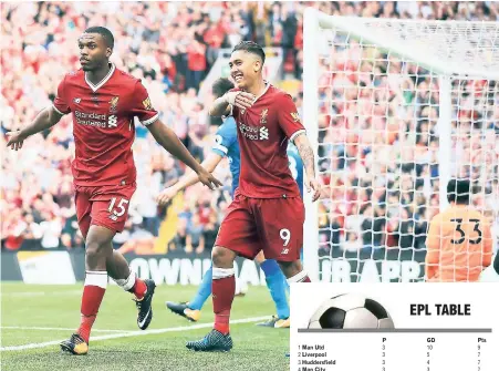  ?? AP ?? Liverpool’s Daniel Sturridge (left) celebrates scoring his side’s fourth goal with teammate Roberto Firmino during their football match against Arsenal in the English Premier League at Anfield, Liverpool, yesterday.