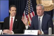  ?? MARK LENNIHAN — THE ASSOCIATED PRESS ?? New York Gov. Andrew Cuomo, left, and Mayor Bill de Blasio discuss the state and city’s preparedne­ss for the spread of the coronaviru­s in New York on Monday, March 2.