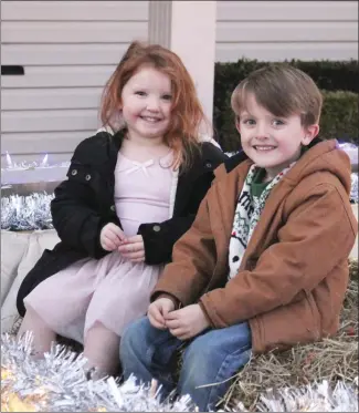  ?? Brodie Johnson • Times-Herald ?? McKinlee Brock, 3 and Carson Brock, 5, are ready for the Christmas parades to begin in the area. The children take a break from working on the float at the Oak Hill Church of God that they’re helping build for the parades. Forrest City’s parade will begin at 7 p.m., Friday, and the parade in Palestine is scheduled to begin at 7 p.m., on Saturday.