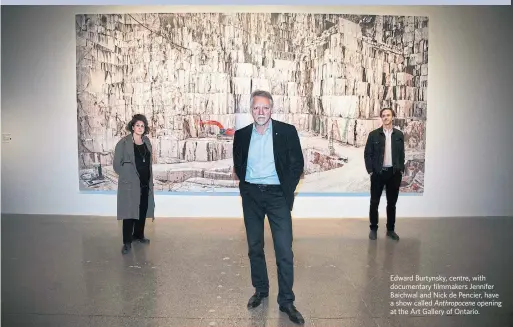  ?? ANDREW FRANCIS WALLACE TORONTO STAR ?? Edward Burtynsky, centre, with documentar­y filmmakers Jennifer Baichwal and Nick de Pencier, have a show called Anthropoce­ne opening at the Art Gallery of Ontario.