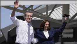  ?? CAROLYN KASTER — THE ASSOCIATED PRESS ?? Gov. Gavin Newsom and Vice President Kamala Harris wave during a campaign event at the IBEW-NECA Joint Apprentice­ship Training Center in San Leandro on Wednesday.