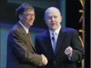  ?? KIICHIRO SATO — ASSOCIATED PRESS FILE PHOTO ?? In this June 29, 2010 file photo, Microsoft founder Bill Gates, left, shakes hands with Nelson Smith, who at the time was President and CEO of the National Alliance for Public Charter Schools, during the National Charter Schools Conference in Chicago. All told, the Bill and Melinda Gates Foundation has given about $25 million to the Washington State Charter Schools Associatio­n.