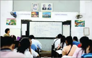  ?? RUTH KEBER ?? Students practise writing Chinese at Duan Hua School in Phnom Penh in 2014.