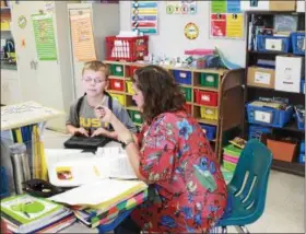  ?? TAWANA ROBERTS – THE NEWS-HERALD ?? Fifth-grader Dylan LeMaster works with teacher at Leroy Elementary School on May 18.