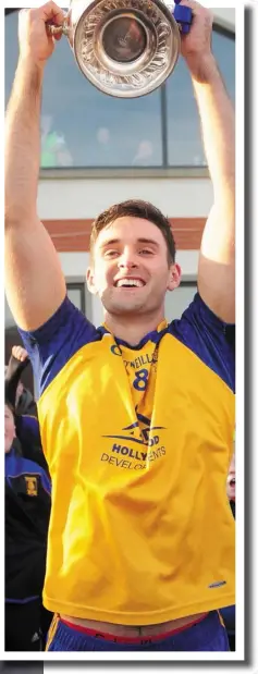  ??  ?? The St Mochta’s players celebrate their success and above, captain Darren McMahon holds the Seamus Flood Cup aloft.