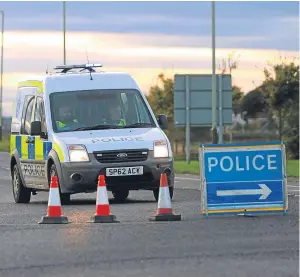  ?? Picture: Kris Miller. ?? Police man the road closure at Barry after the crash on Friday which left a 27-year-old man dead.