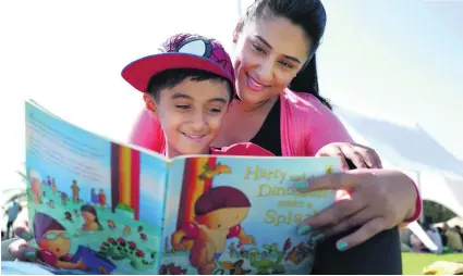  ?? Delores Johnson / The National ?? Eight-year-old Jamaal Hussain and his mother, Saiqa Hussain, were happy to spend time together reading during the very first Happiness Festival, which kicked off in Dubai yesterday. The event was held at the Dubai Polo and Equestrian Club.