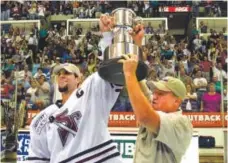  ?? Photo courtesy of South Carolina Stingrays ?? As captain of the ECHL’s South Carolina Stingrays in 2001, Jared Bednar raises the league's championsh­ip trophy, the Kelly Cup.