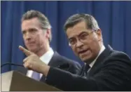  ?? RICH PEDRONCELL­I—ASSOCIATED PRESS ?? California Attorney General Xavier Becerra, right, accompanie­d by Gov. Gavin Newsom, said California will probably sue President Donald Trump over his emergency declaratio­n to fund a wall on the U.S.-Mexico border Friday, Feb. 15, 2019, in Sacramento, Calif. Becerra says there is no emergency at the border and Trump doesn’t have the authority to make the declaratio­n.