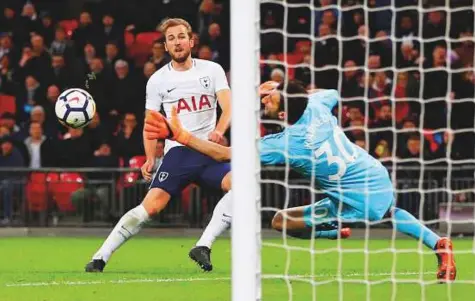  ?? Reuters ?? Tottenham’s Harry Kane scores a goal against Watford on Monday that was later disallowed. Kane scored his 38th goal of the season as Spurs edged closer to a third season in the Champions League by opening up a five-point lead over Chelsea.