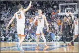  ?? [AP PHOTO/SEAN RAYFORD] ?? Virginia guard Kyle Guy (5) and Ty Jerome (11) celebrate during a 71-56 win against GardnerWeb­b on Friday.