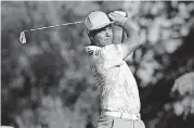  ?? [AP PHOTO] ?? Rickie Fowler watches his tee shot Friday during the Wells Fargo Championsh­ip golf tournament at Quail Hollow Club in Charlotte, N.C.