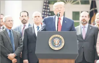  ?? — AFP photo ?? Surrounded by members of the White House Coronaviru­s Task Force, Trump speaks at a press conference on Covid-19 in the Rose Garden of the White House in Washington, DC.